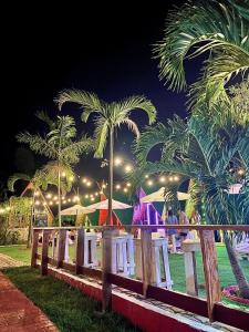 a group of tents and palm trees at night at Glamping Alona in Panglao