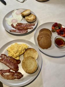 three plates of breakfast foods on a table at Summer Breeze Guest House in Newquay