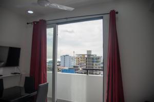 a room with a large window with red curtains at Resting View in Male City