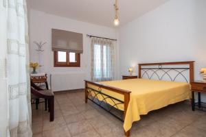 a bedroom with a yellow bed in a room at Potami Mountain in Karlovasi