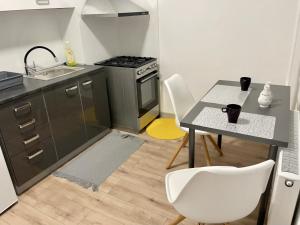 a small kitchen with a table and a sink at City Ela Center in Košice