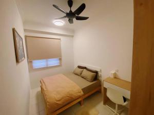 a small bedroom with a bed and a ceiling fan at RumaMuji Kita KLIA, Putrajaya, Cyberjaya Musliem Only in Sepang