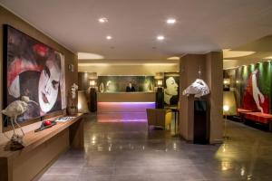 a lobby of a building with a man in the background at Park Hotel Sabina in Magliano Sabina