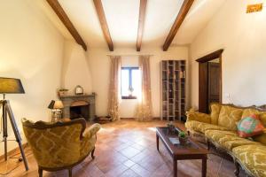 a living room with a couch and a fireplace at Poggio ai Legni in Certaldo