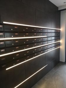 a wall of metal boxes with lights on it at Alexandra view studio in Braşov