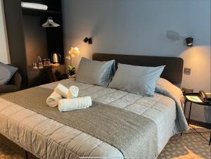 a bedroom with a bed with towels on it at Victoria by Petit Chic in Mellieħa