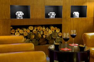 two glasses of wine on a table in front of a wine cellar at Park Hotel Sabina in Magliano Sabina