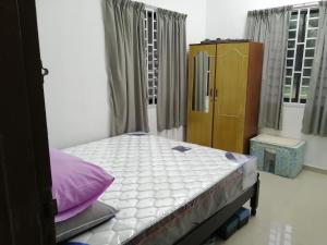 a bedroom with a bed in a room at KJS Homestay, Layang-Layang, Johor in Kangkar Lanjut