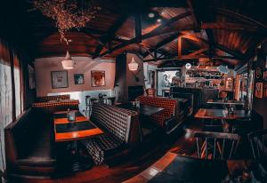 a restaurant with tables and chairs and a bar at Tico Pousada - Campos do Jordão in Campos do Jordão