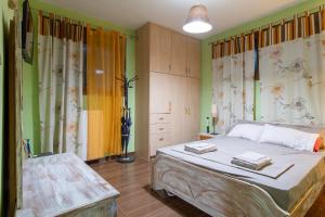 a bedroom with a bed and a dresser in it at Alice house 3 in Amarynthos +44 photos