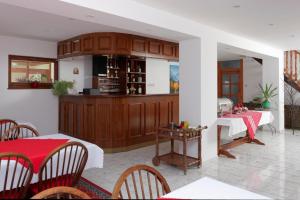 a dining room with two tables and a kitchen at Penzión U Aleny in Ždiar +16 photos