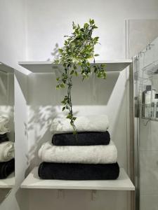 a pile of towels on a shelf in a bathroom at Boutique penthouse apartment with rooftop terrace in Clitheroe