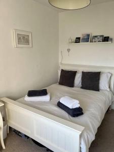 a white bed with two pillows on top of it at Boutique penthouse apartment with rooftop terrace in Clitheroe