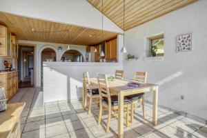 a kitchen and dining room with a table and chairs at Casa Fyrrevænget in Billund