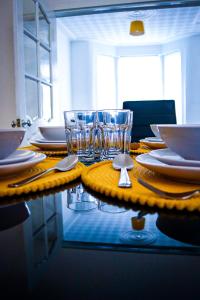 a table with plates and glasses on top of it at Large Walton House - EFC & LFC in Liverpool