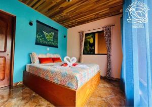 a bedroom with a bed with a bow on it at TucanTico Lodge - Monteverde in Monteverde Costa Rica