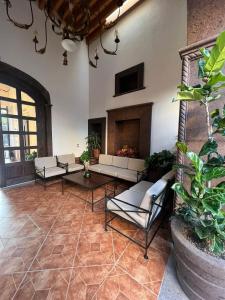 a living room with couches and a fireplace at Hotel Boutique Rincón de Luna in San Juan del Río