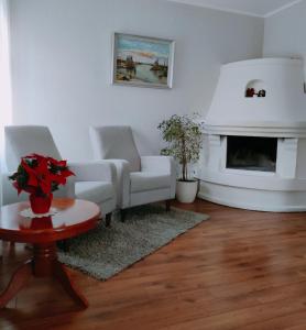 a living room with two couches and a fireplace at Amrai in Ventspils