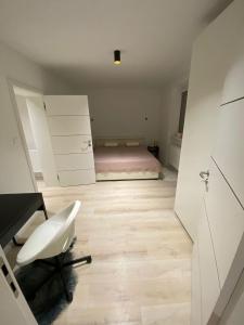 a bedroom with a bed and a desk and a chair at Apartman M&M in Žilina