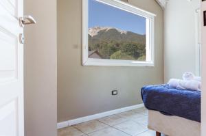 a room with a window with a view of a mountain at BOG Las Frutillas in Villa La Angostura