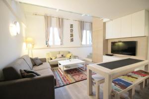 a living room with a couch and a table at Duplex lumineux et spacieux in Nice
