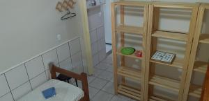 a small room with a chair and a cabinet at Aconchego em Floripa in Florianópolis