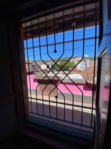 a window with a view of a beach seen through it at Happy Place in San Cristóbal de Las Casas