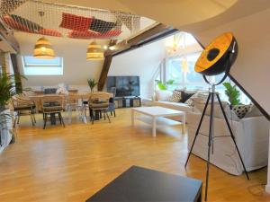 Televízia a/alebo spoločenská miestnosť v ubytovaní Appartement Panoramique