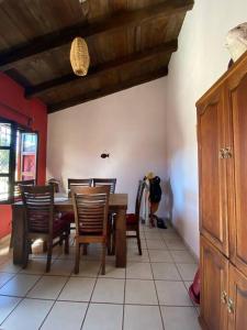 a dining room with a wooden table and chairs at Happy Place in San Cristóbal de Las Casas