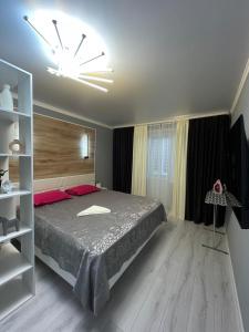1 dormitorio con cama grande y ventana grande en Бизнесс Апартаменты Центр Уральск en Oral