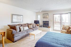 a living room with a couch and a fireplace at Timber Run Vista 2 in Winter Park