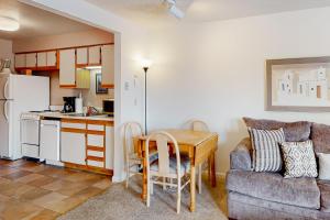 a kitchen and dining room with a table and a couch at Timber Run Vista 2 in Winter Park