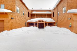 a building covered in snow with snow piled up at Timber Run Vista 2 in Winter Park