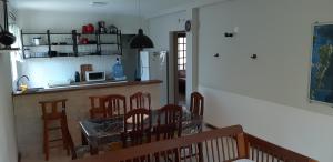 a kitchen and dining room with a table and chairs at Aconchego em Floripa in Florianópolis