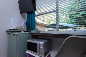 a desk with a computer monitor and a window at Rozelee Rest in Nelspruit