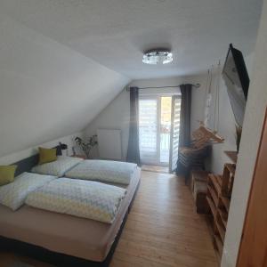 a bedroom with two beds and a staircase at Ferienwohnung Zum Moor in Monschau