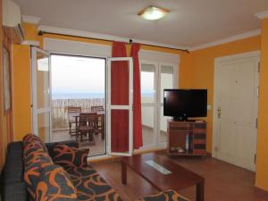 a living room with a couch and a flat screen tv at ÁTICO CARBONERAS PENTHOUSE in Carboneras