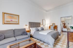 a living room with a bed and a couch at Living Rome Repubblica apartment in Rome