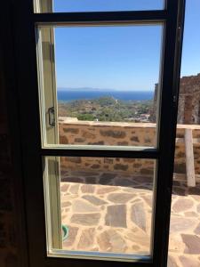 a window with a view of the desert outside at Lemon's Cottage House, Volissos, Chios in Volissos