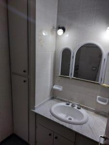 a bathroom with a sink and two mirrors at La Porota in Ramallo +38 photos