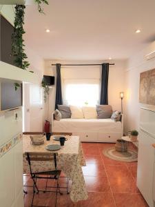 a living room with a white couch in front of a window at Casa del Castillo by Naturadrada in La Adrada +119 photos