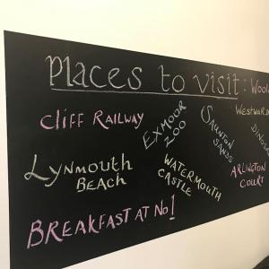 a chalkboard with places to visit written on it at Lovely flat located in heart of Lynton. in Lynton