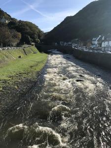 a river with rapids on the side of it at Lovely flat located in heart of Lynton. in Lynton