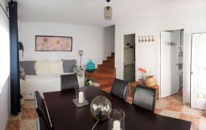 a dining room and living room with a table and chairs at Casa del Castillo by Naturadrada in La Adrada