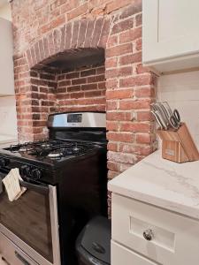 a brick oven in a kitchen with a brick wall at Classical Isbills Row House close to NYC in Bayonne