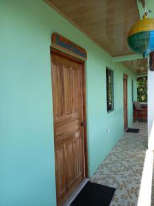 una puerta delantera de una casa con un cartel en ella en Hospedaje Rosa Del Mar, en Isla Grande del Maíz