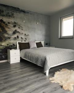 a bedroom with a large bed and a white rug at MoonLight in Slavske