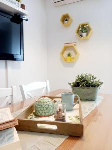 a tray on a table with a cup and a plant at Apartment Megi in Supetar historical core in Supetar