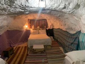 a room with two beds in a cave at Dar Fatma Toujane in Tūjān