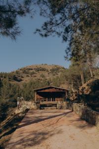 a dirt road in front of a pavilion on a hill at Bosco Paradiso in Limassol